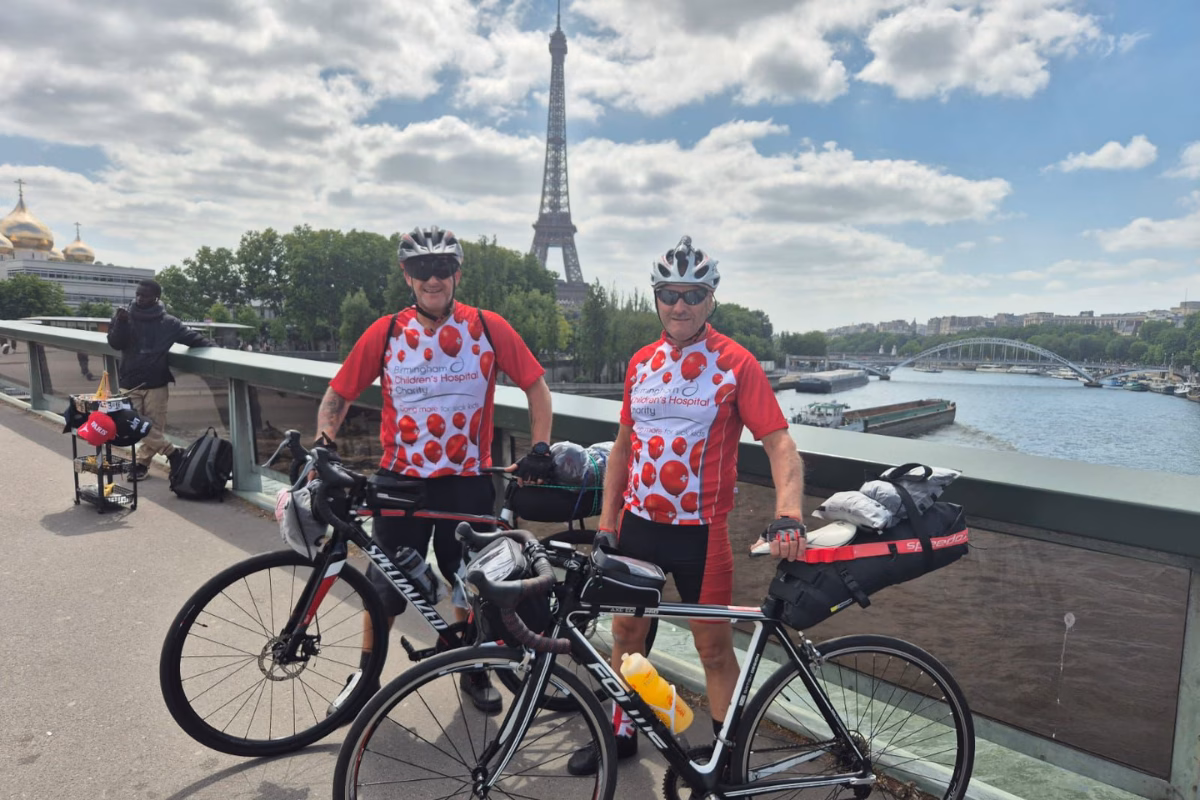 Paul and Vinny on bikes with the Eiffel Tower in the background