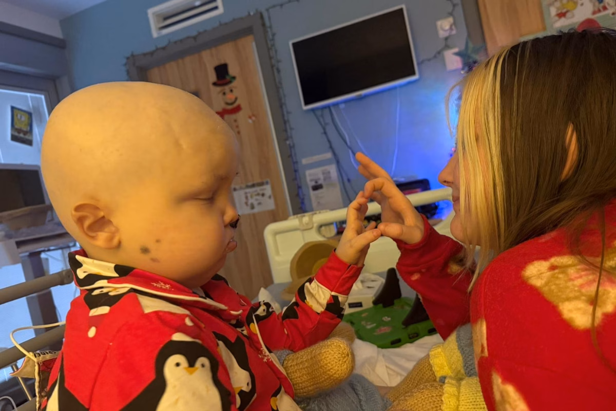 5-year-old Marley playing with his mum at Christmas in a hospital bed