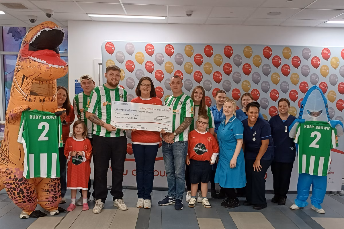 Family holding fundraising cheque