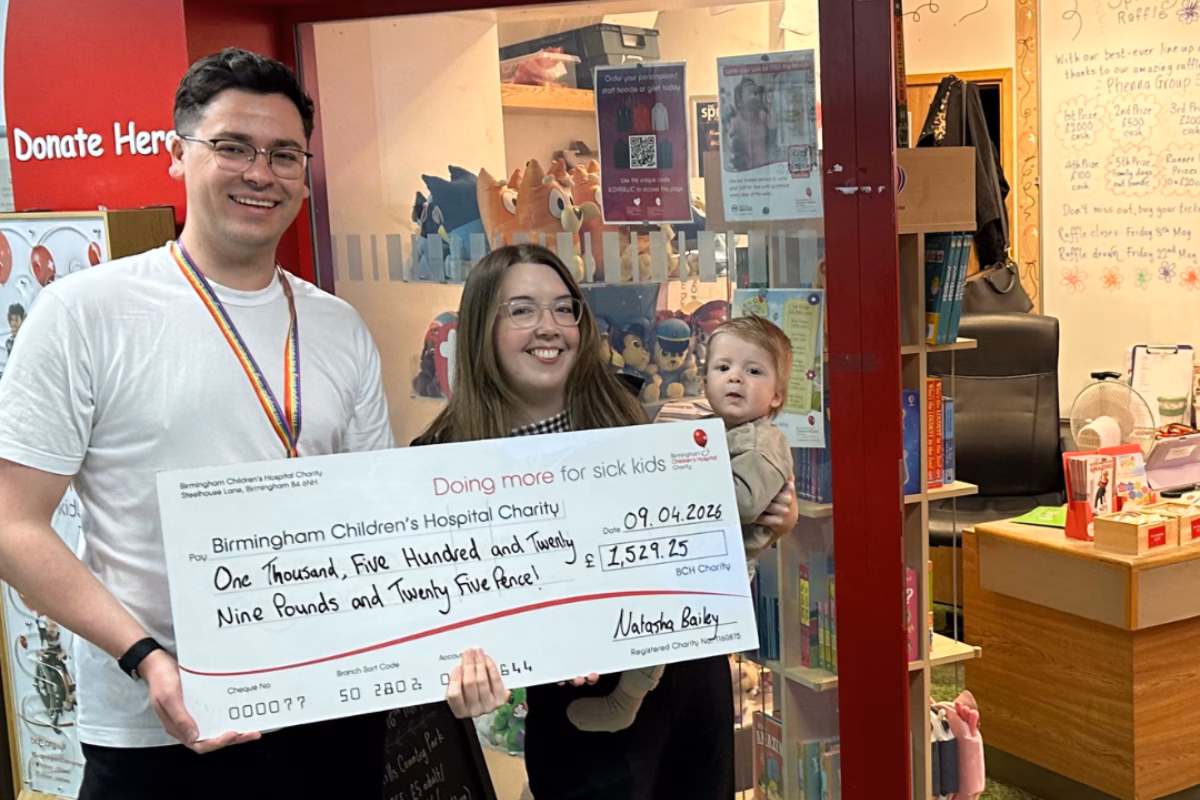 Natasha Bailey with Archie holding fundraising cheque