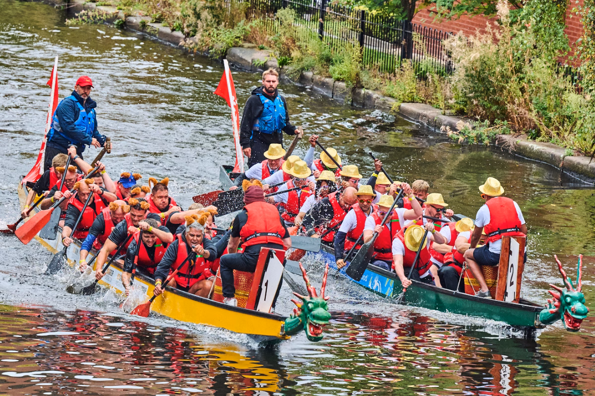 Two teams racing dragon boats on the canal