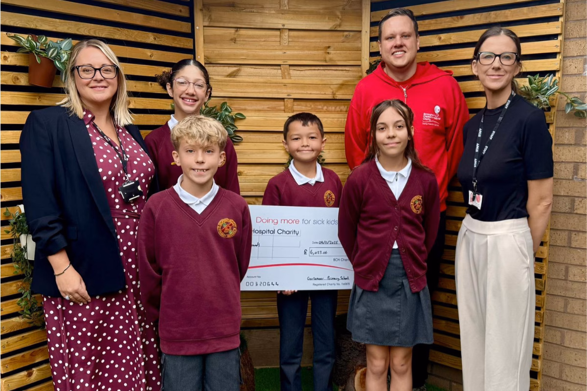 Gorsemoor Primary School co headteachers and students holding their fundraising cheque