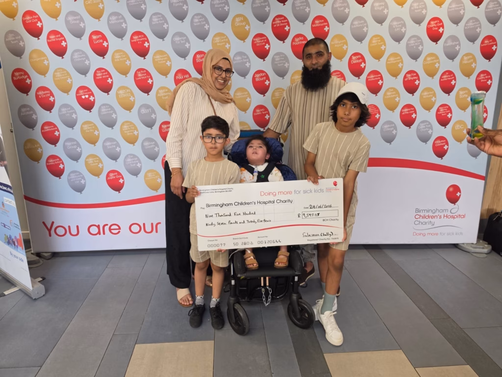 Family holding fundraising cheque