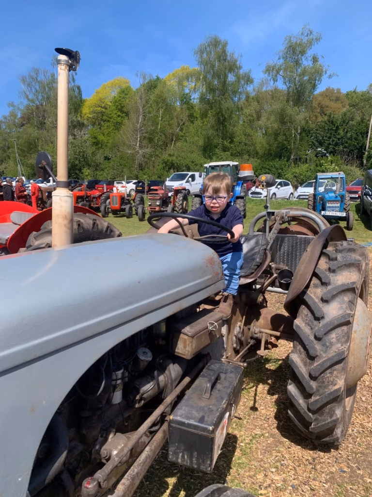 Toby sitting on a stationary tractor