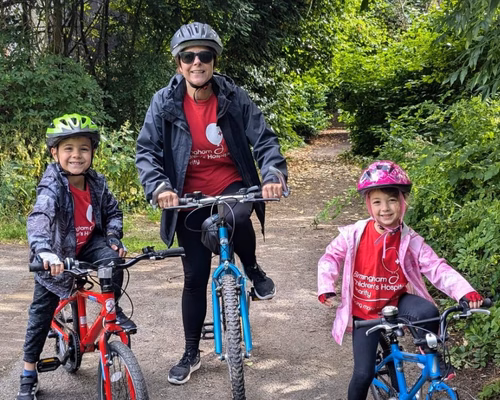 A woman and two young children on bikes