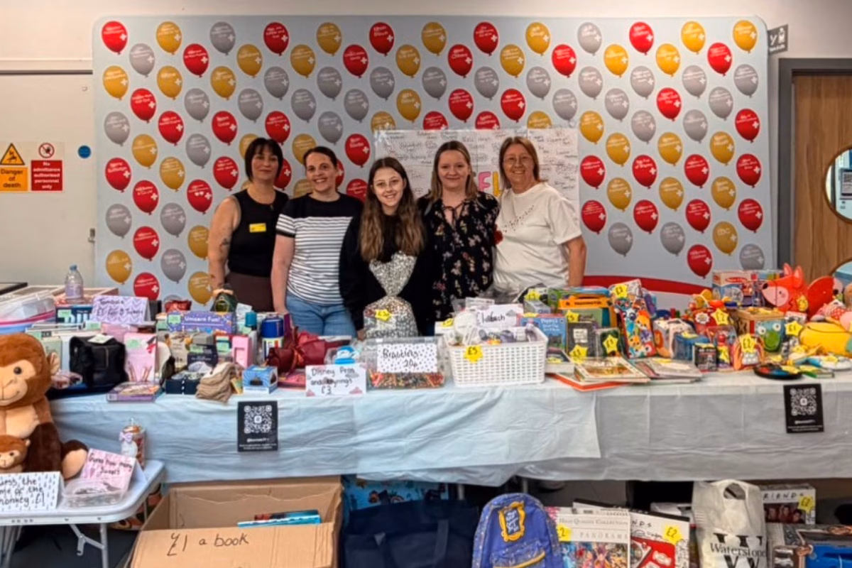 Group of women in front of fundraising stand