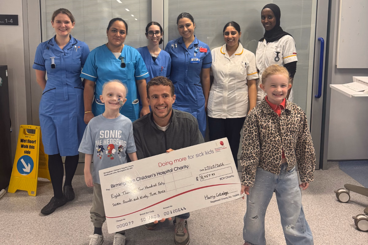 River and Harry with oncology staff holding giant fundraising cheque