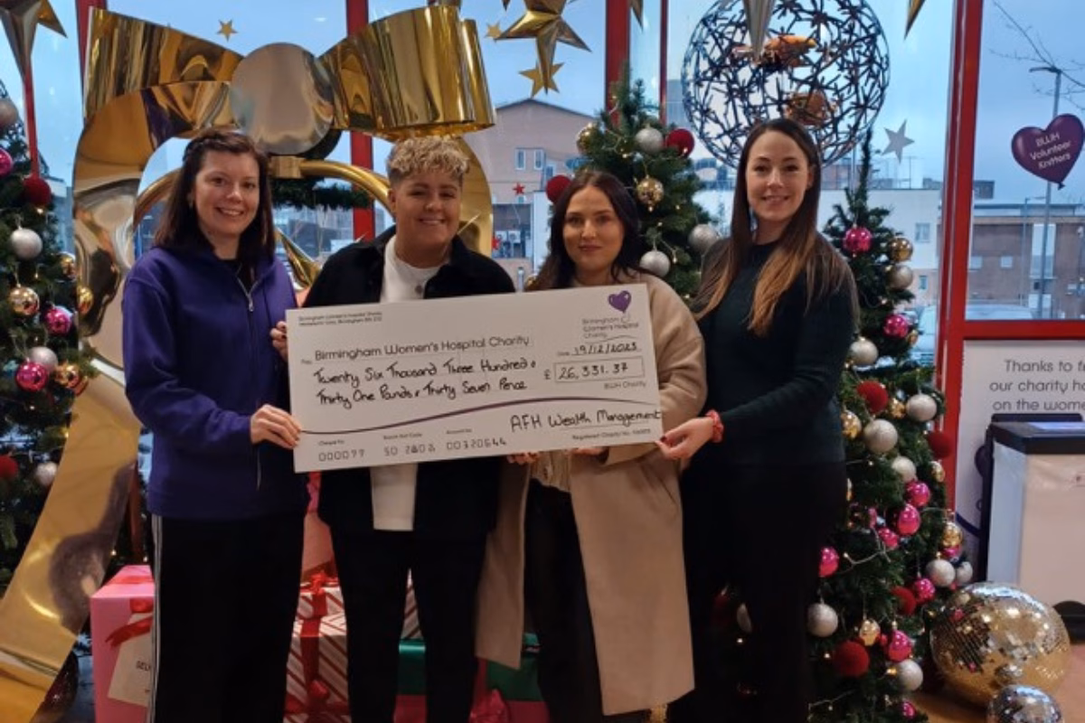 AFH Wealth Management at Christmas, holding fundraising cheque for £26,331