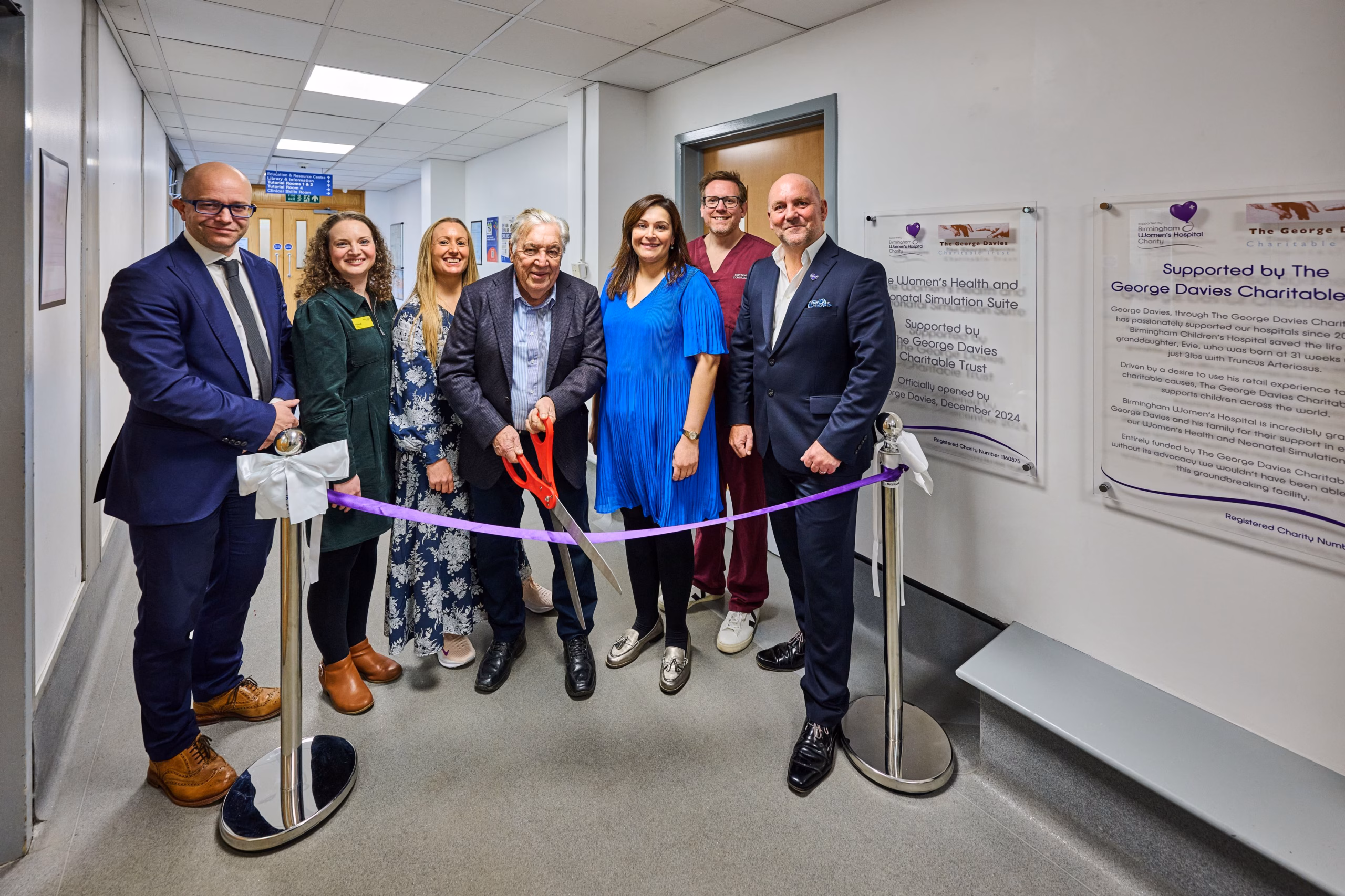 Ribbon cut to open new facility, with members of Trust and charity staff