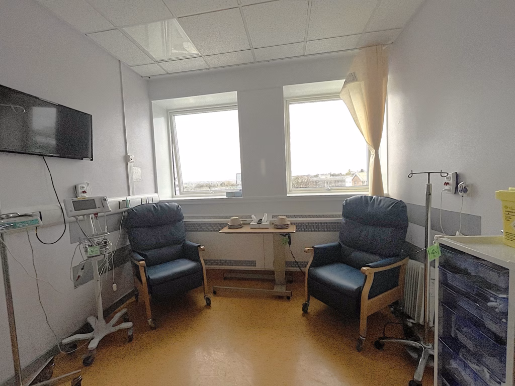 Two chairs in EPAU in a dimly lit and clinical environment